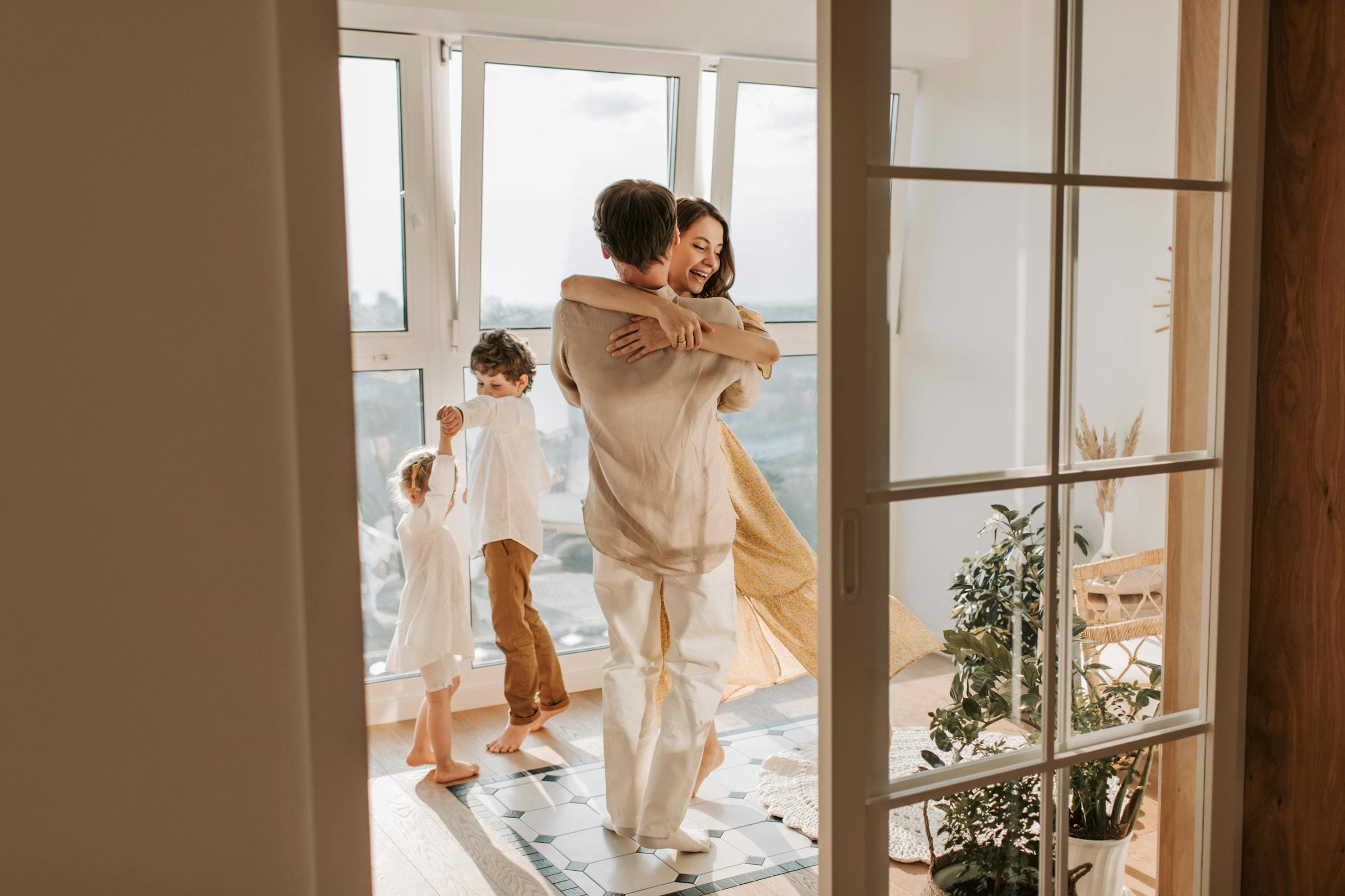 Happy family dancing and enjoying their home together