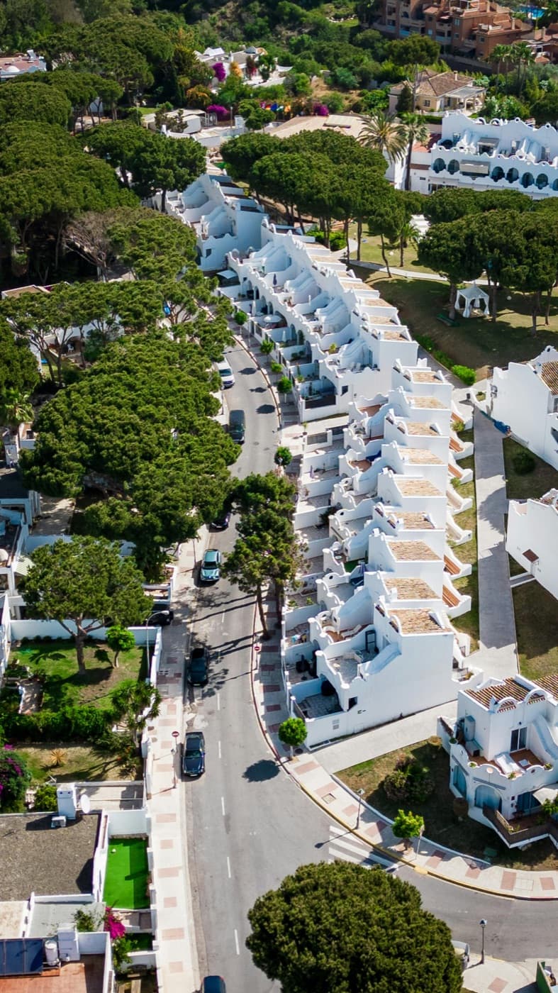 A coastal Spanish residential development at dusk.